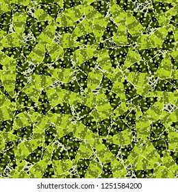 Seamless pattern. The motley green leaves are scattered randomly against a background of abstract texture. Camouflage style.
