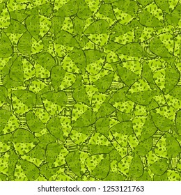 Seamless pattern. The motley-green leaves of maple lying on a background of coarse and openwork weaving. Camouflage.