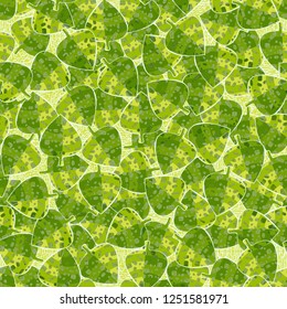 Seamless pattern. Motley-green leaves in random order are placed against the background of the wood-parquet texture. Camouflage style.