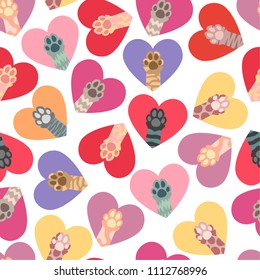 Seamless pattern of multi-colored cat paws in red, yellow and blue hearts. Love symbol, card, texture.