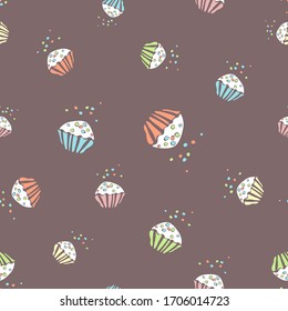 Seamless pattern of multicolored cupcakes on a brown background