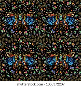 Seamless pattern. Multicolored Dead head butterfly in a flower garden. Moth among flowers and leaves. Ideal for decoration of Halloween and the Day of the Dead.