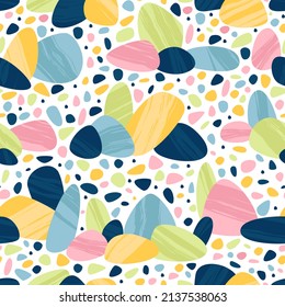 Seamless pattern of multicolored grouped pebbles. Multicolored summer fabric design for kids and adults. Flat vector illustration.