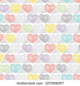 Seamless pattern with multi-colored hand-drawn hearts.