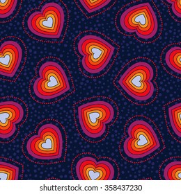 Seamless pattern with multicolored hearts in red, yellow, blue and purple colors on dark blue background