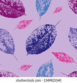 Seamless pattern of multi-colored leaves on a purple background, vector illustration.