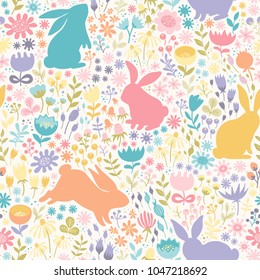 Seamless pattern of multicolored silhouettes of rabbits and wildflowers.Hand-drawn vector texture