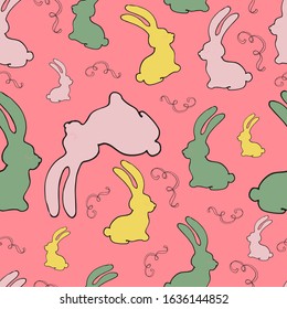 Seamless pattern with multi-colored silhouettes of rabbits. Can be used for fabric, packaging and easter celebration. Vector graphics.