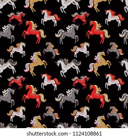 Seamless pattern. Multicolored unicorns on a black background. Horses galloping. Magic creatures. Cute vintage ornament.