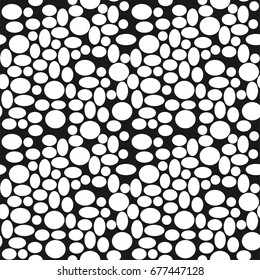 Seamless pattern with a multitude of different ovals on a dark background. Abstract hand drawn texture.  Texture with monochrome elements. Vector illustration.
