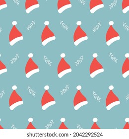 Seamless pattern of New Year and Christmas. Winter elements of Santa's hat on a blue background. Christmas vector illustration in the doodle style. Design for gift packaging, office, poster.