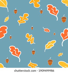 Seamless pattern of oak leaves and acorns, blue background. Autumn color print. Background for fabric, wallpaper, textile, wrapping paper. Doodle vector illustration