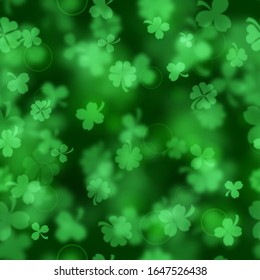 Seamless pattern on St. Patrick's Day made of blurry clover leaves in green colors