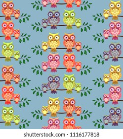 seamless pattern on the theme of family and nature. A family of owls sitting on a tree branch among flowers and butterflies.