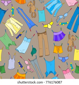 Seamless pattern on the theme of washing and cleanliness, various clothes , a color icons on brown background