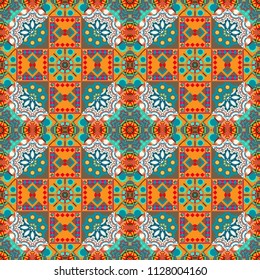 Seamless pattern in orange, brown and blue colors. Vector background with tiles and rhombus. Vector geometrical seamless ornament.