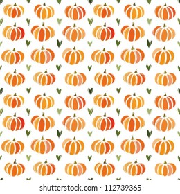 Seamless pattern with orange pumpkins and hearts