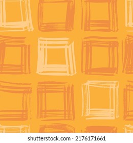 Seamless pattern from orange squares from brushstrokes on orange background