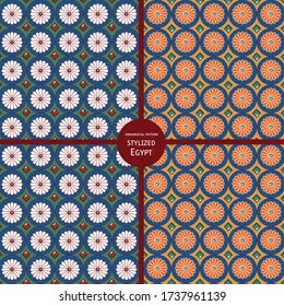 Seamless pattern with orange and white daisies with an insert of emeralds and rubies in the Egyptian style on a blue background.
