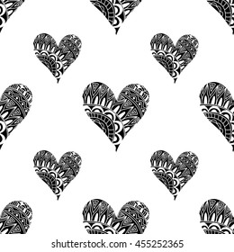Seamless pattern with ornamental black hearts on white background in doodle style