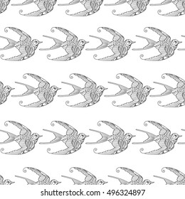 Seamless pattern with ornamental swallow birds hand drawn isolated on white background. Can be used for coloring book for adult and older children. Vector illustration.
