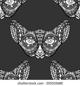 Seamless pattern with ornate doodle graphic monochrome cat faces. Hand drawn doodle. Ethnic patterned vector illustration. African, indian, totem design. Sketch for wallpaper, posters.