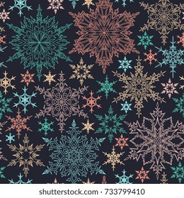Seamless pattern with outline blue, yellow, rose and red snowflakes on dark background. Winter background. Abstract wallpaper, wrapping, cover, textile endless texture. Christmas geometric ornament.