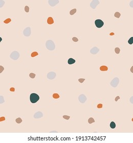 Seamless pattern with oval multi-colored spots. Beige, orange, green stones, mosaic and terrazzo texture. For decor, textiles, fabrics, packaging, wrapping paper, wallpaper, design, banners, templates