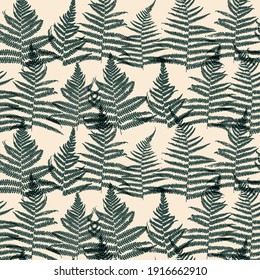 Seamless pattern with overlapping green fern leaves on pink champagne color background for natural textile design