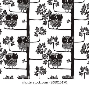 Seamless pattern of owls on the tree. Graphic vector illustration.