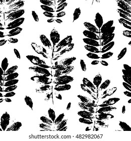 Seamless pattern with paint prints of leaves