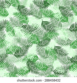 Seamless pattern of palm leaves branches superimposed on each other beautifully green on a white background