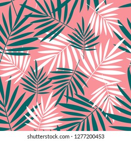 Seamless pattern with palm leaves on a pink background. Tropical background.