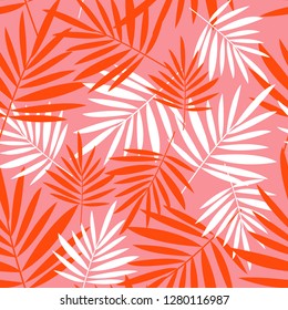 Seamless pattern with palm leaves on a pink background. Tropical background.
