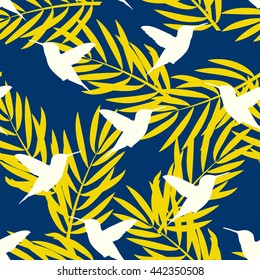 Seamless pattern with palm sheets and hummingbird. Vector background
