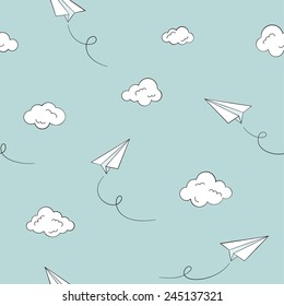 Seamless pattern with paper planes and clouds