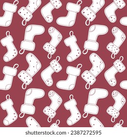 Seamless pattern with PaperCut-style Christmas socks. Wrapping paper with red background and white vintage socks