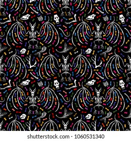 Seamless pattern. Parts of skeletons of different animals and skeletons of bats among colored bones. Great for printing on fabrics. Ideal for decoration of Halloween and the Day of the Dead.