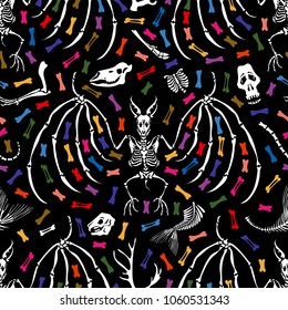 Seamless pattern. Parts of skeletons of different animals and skeletons of vampire bats among colored bones. Great for printing on fabrics. Ideal for decoration of Halloween and the Day of the Dead.