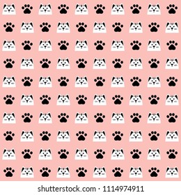 Seamless pattern with paw print and cat face. Black pawprint and white cat head on pink background. Design for textile, wallpaper, fabric. Pet care symbol. Repeat ornament