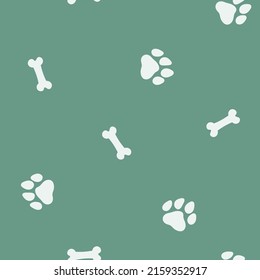 Seamless pattern with paw prints and bones. 