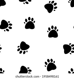 Seamless pattern with paws of animals in black on a white background.