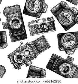 Seamless pattern with photo cameras. Vector illustration in vintage engraved style on white background.  