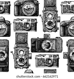 Seamless pattern with photo cameras. Vector illustration in vintage engraved style on white background.  