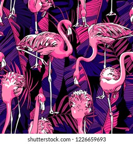 Seamless pattern. Pink Flamingos and a  lilac Tropical banana, purple exotic palm leaves at a dark violet night. Textile composition, hand drawn style print. Vector illustration.