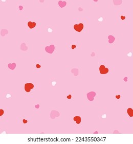 Seamless pattern with pink and red hearts. Vector design