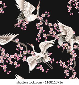 Seamless pattern with pink sakura branches and white Japanese cranes. Vector