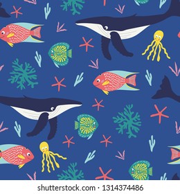 Seamless pattern of playful humback whales, happy tropical fish, octapus, and bright corals in the deep blue ocean. Great for textile print, wallpaper, or packaging. Vector file.