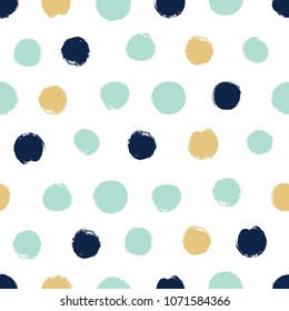 Seamless pattern in polka dots in blue, green and gold tones. Dry brush.
 
