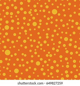 Seamless pattern with polka dots of different sizes. Orange and yellow color. Simple fashionable background for banners, printing on textile, paper, fabrics. Retro, vintage style 50s, 60s